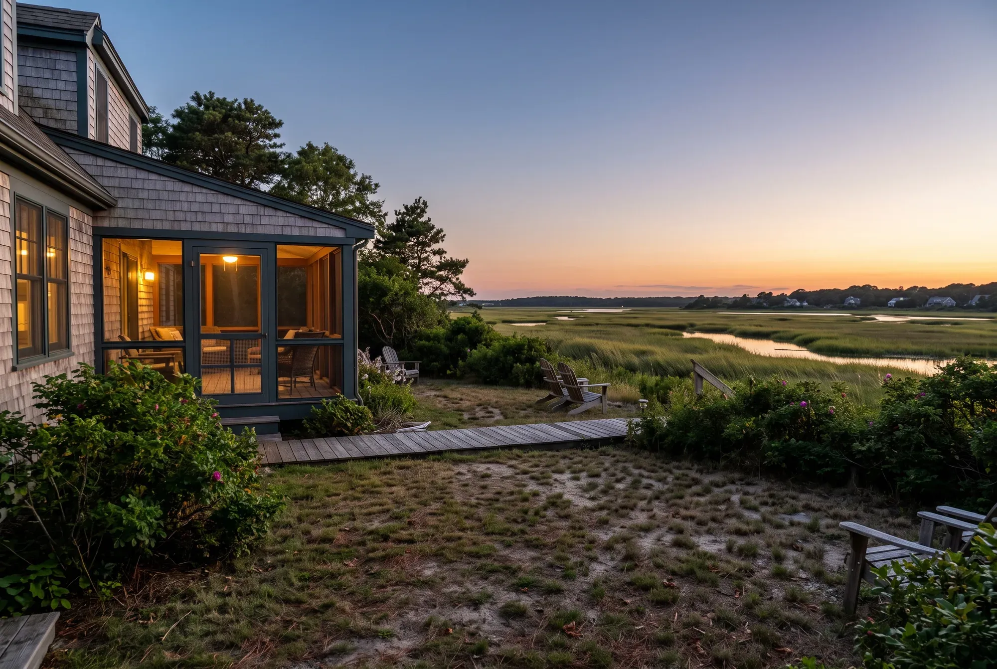 Cape Cod home with a lit screened porch