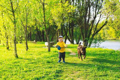 kid and dog in yard