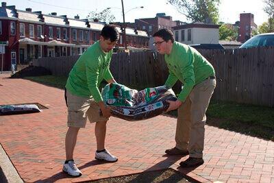 Mosquito Squad Service Day Participants Carrying Mulch