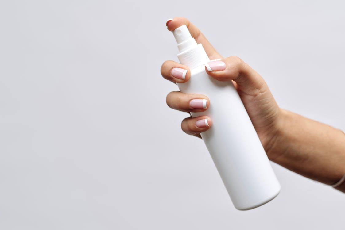 Free Hand of a Person Holding White Plastic Bottle Stock Photo