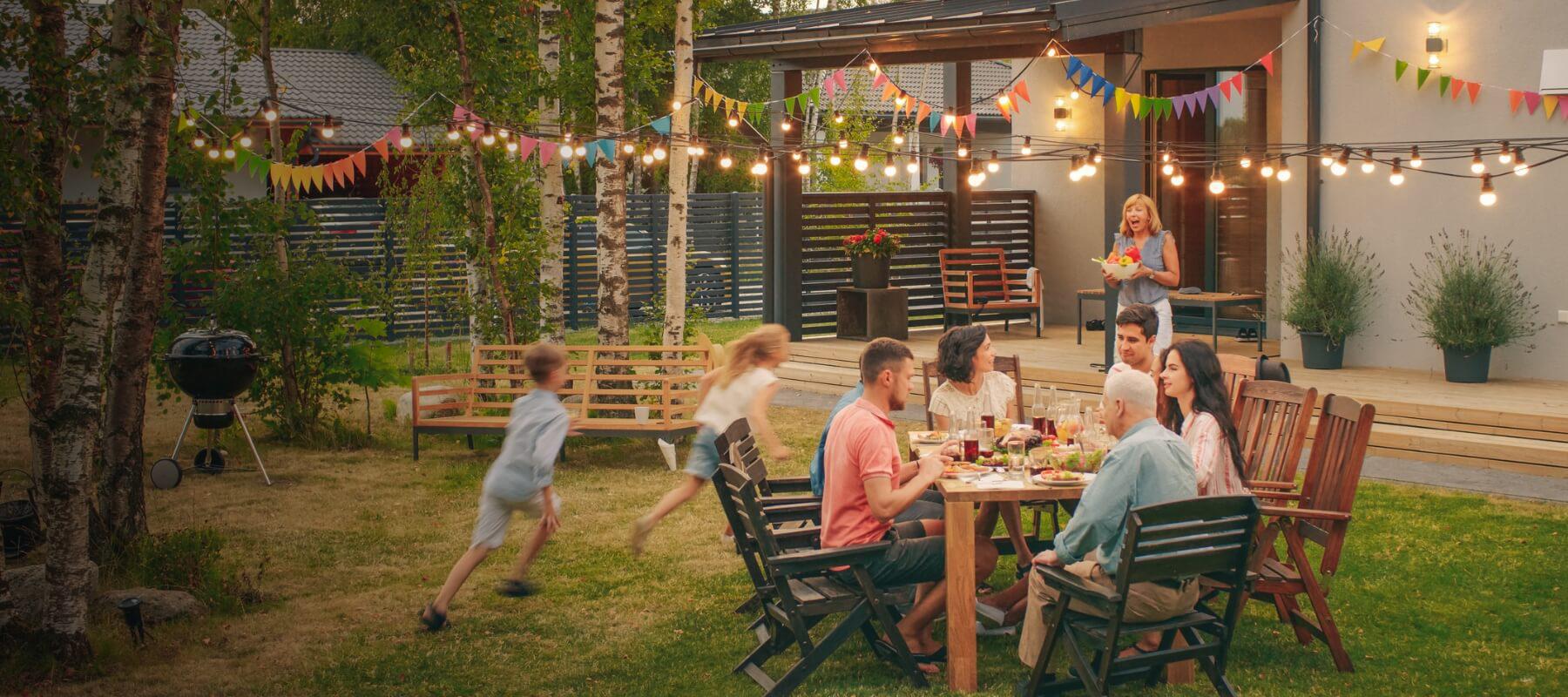 Family sitting around table and playing outdoors