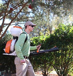 Man spraying mosquito control barrier protection 