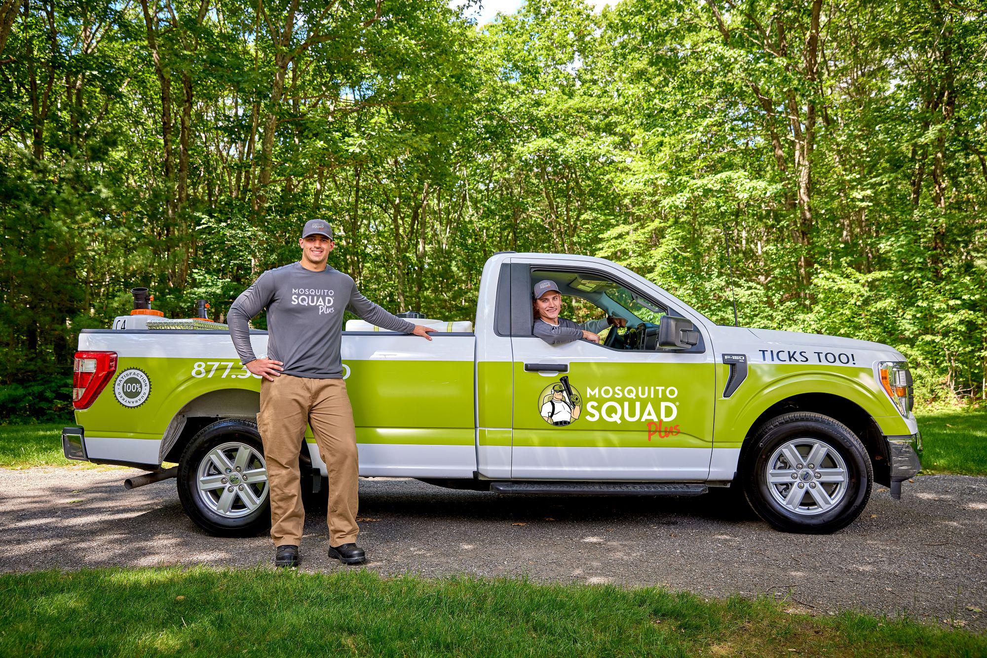 Mosquito Squad Plus truck with technicians standing and sitting in truck