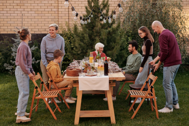 family around picnic table outside