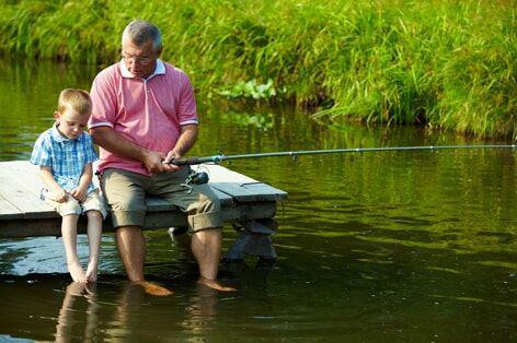 A grandpa and grandchild fishing